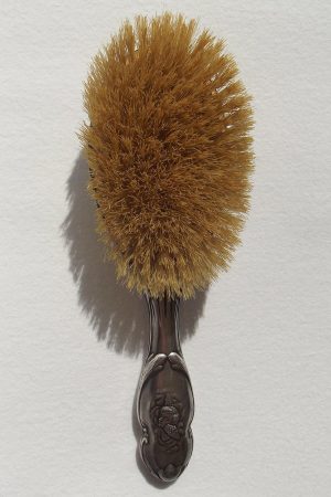 Front of silver hair brush