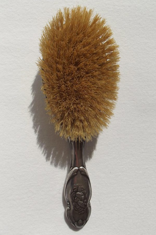 Front of silver hair brush