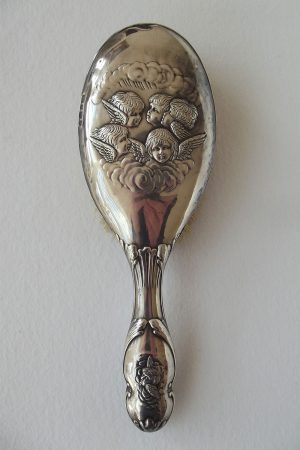 Back of silver hair brush with cherub detail