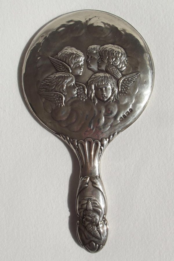 Back of silver hand mirror with cherub detail