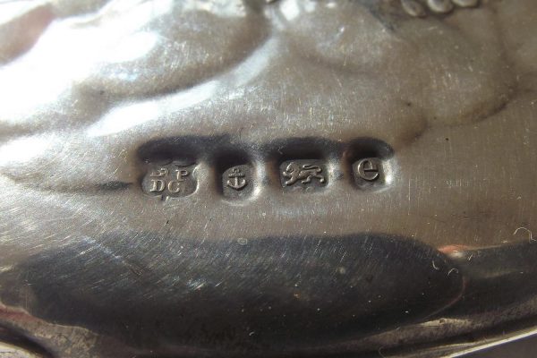 Closeup of hallmarks on silver hand mirror