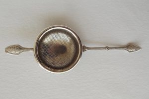 Above shot of silver plated tea strainer