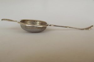 Profile shot of silver plated tea strainer